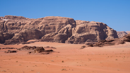 Fototapeta na wymiar Unique red terrain and mountainous landscape of remote Arabian Wadi Rum desert in Jordan, Middle East