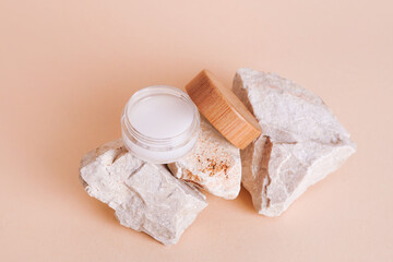 Cosmetic jar wooden lid with cream or lotion on stone podium for product presentation. Skincare cosmetic. Beige background. Beauty concept for face care