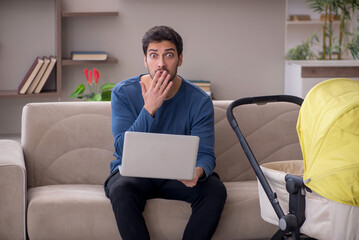 Young male contractor looking after baby at home