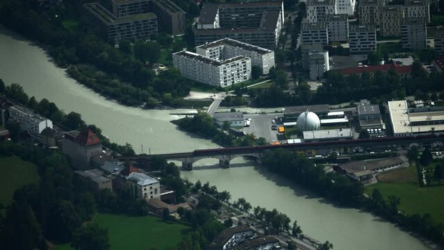 Train Crossing the M&uuml;hlauer Eisenbahn Bridge in Innsbruck, Austria Captured on an Extreme Telephoto Lens
