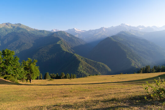Beautiful valley and coniferous mountains of Svaneti in the sunset sunlight. Mestia, Heshkili. Beautiful mountain landscape