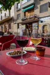 glasses of red wine and white wine and olives
