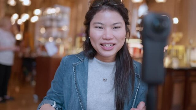 Asia travel vlogger introduce great menu famous restaurant while lives streaming for IG reel instagram tiktok social media platform,Social media influencer online video of food at cafe, smartphone