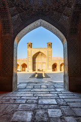 Fototapeta na wymiar View of northern iwan from prayer hall, the Vakil Mosque