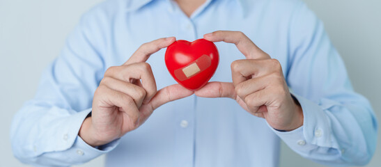 man hand holding red heart shape. love, donor, world heart day, world health day and Insurance concepts