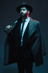 Fashion, criminal and man in studio with bat for vintage, retro and Victorian gangster on dark...