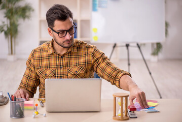 Young male designer working in the office