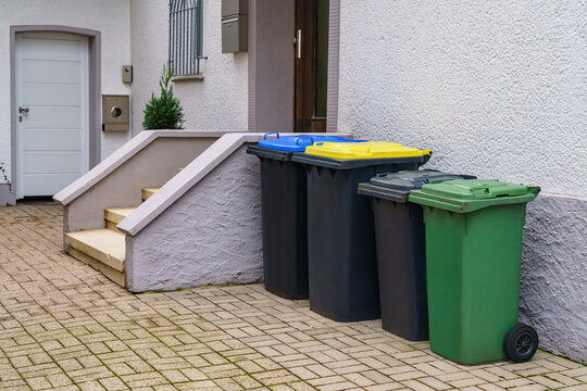 Plastic containers for garbage near the entrance to a residential building