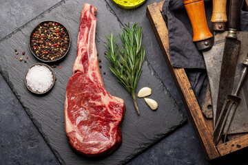 Raw Tomahawk beef steak and spices