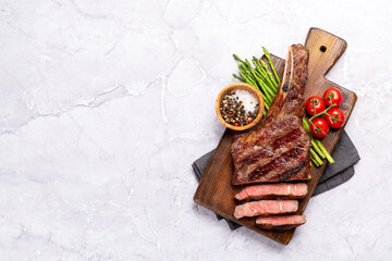 Medium rare grilled Tomahawk beef steak with asparagus