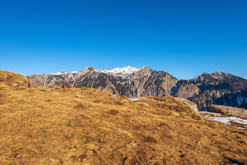 Fototapeta na wymiar Lessinia High Plateau Regional Natural Park (Altopiano della Lessinia) and the mountain peak of Monte Carega (small Dolomites). Bosco Chiesanuova, Verona province, Veneto and Trentino, Italy, Europe.