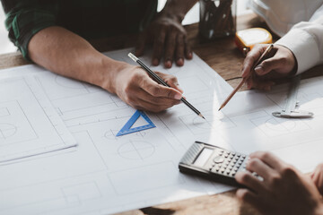 Architects and engineers are working together to edit the draft house plan that was designed after it was presented to the client and partially revised the design. Interior design and decoration ideas