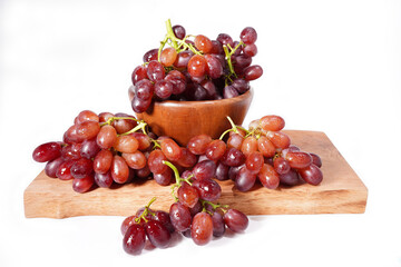 bunch of red seedless grapes on a white background