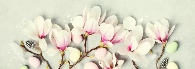 Gordijnen Easter banner with beautiful spring magnolia flowers and Easter decoration on grey stone background. Easter concept © Natalia Klenova