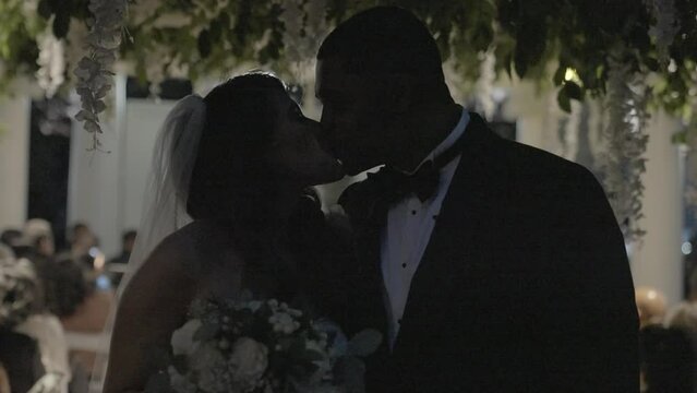 Bride and groom kissing as they leave wedding party. Lights flashing while couple is photographed. Shot in 4K 60 FPS. To purchase entire event raw at wholesale price email willneatheryyahoo.com.
