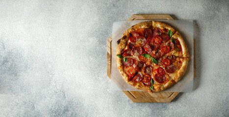 Italian pizza Margherita with tomatoes, basil and mozzarella cheese. Pizza Margarita on grey stone background, top view. Copy space for text. Web banner, menu for restaurant, cafe, recipe concept