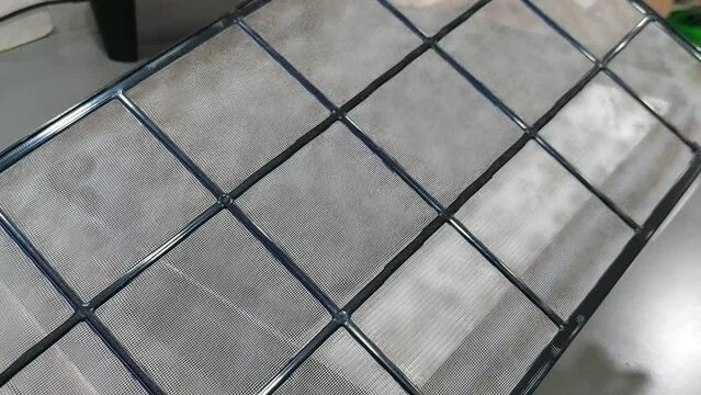 Dirty mini pleated HEPA filter, one of air purifier component to trap dust, bacteria, virus, and pollutants in the air