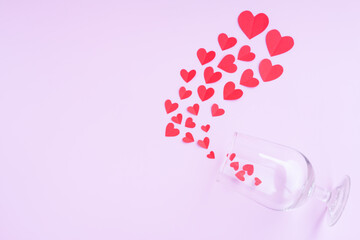 Wine glass with  Red paper hearts shape on pink background, Happy Valentine's day