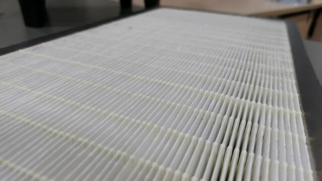 Dirty mini pleated HEPA filter, pre filter and carbon air filter of air purifier component to trap dust, bacteria, virus, and pollutants in the air