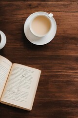 still life book and a cup of tea in the living room on a wooden table, the concept of coziness and interior - generative ai