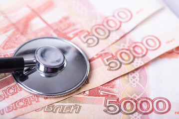 Top view on stethoscope and ruble banknote. Ruble inflation and devaluation concept