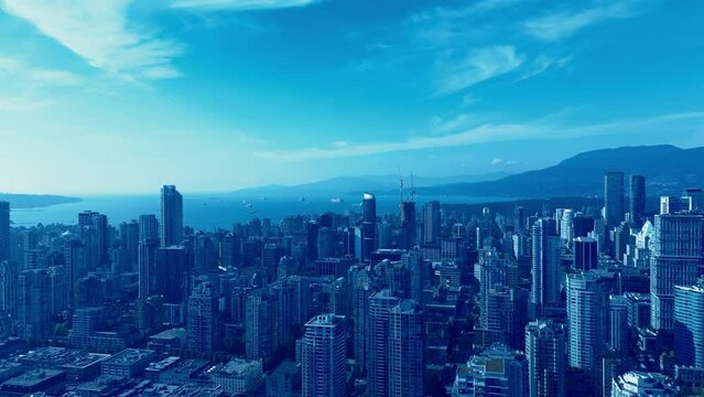 Vancouver downtown post modern city reborn architectural marvel construction new modern futuristic buildings erecting on sunny summer day within a mountain valley with freighter ships harbor in line
