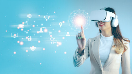 Asian businesswoman wearing virtual reality goggles headset finger, watching and touching digital icon. Technology and Businese.
