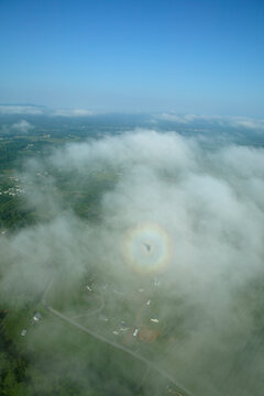 Shadow of an ultralight trike within a circular rainbow - known as