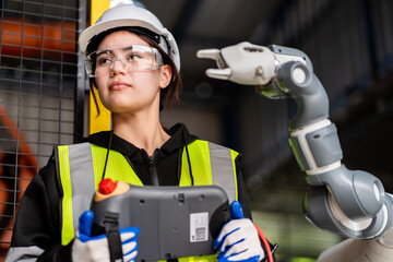 A team of male and female engineers meeting to inspect computer-controlled steel welding robots. Plan for rehearsals and installation for use.