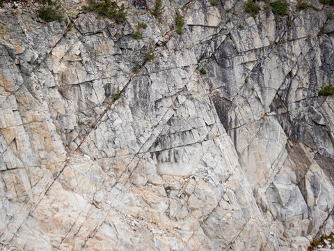 Paralell cracks run through a rocky cliff in the Wallowa Mountains