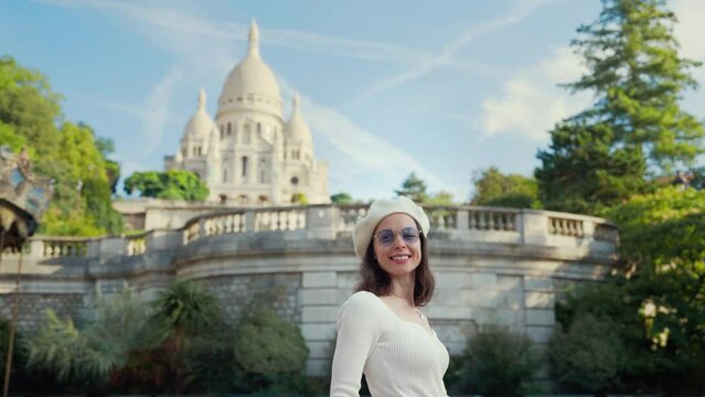 Happy girl in a famous tourist place next to the carousel and the Sacre Coeur