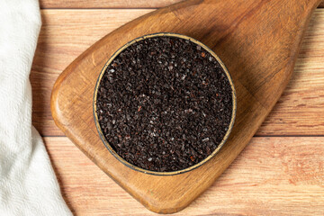 Black hot pepper spice in bowl. Chili pepper is a hot spice obtained by drying the pepper in the sun. Dry spice concept. local name isot. Top view