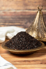 Black hot pepper spice in bowl. Chili pepper is a hot spice obtained by drying the pepper in the sun. Dry spice concept. local name isot. close up