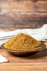Powdered cumin spice. Cumin spice in bowl on wooden background. Dry spice concept. close up
