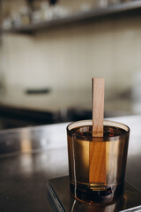 liquid candle wax is poured into a glass jar