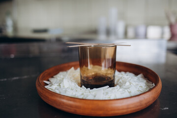 Handmade ecological and vegan soy wax candles with wooden wick. Amber and opaque container. Candle making utensils. Cruelty-free vegan product. Top view