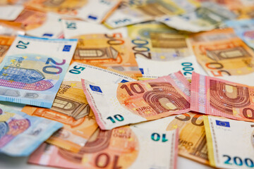 Many euro banknotes as a background with a low depth of field show richness and abundance
