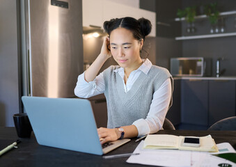 Fototapeta premium Thinking, idea and business Asian woman with laptop working on report, online proposal and project at home. Remote work, documents and female worker with computer for research, strategy and planning