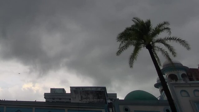 Stormy weather above Mosque in Sylhet Bangladesh, pigeon birds flying