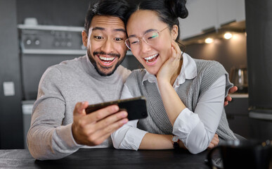 Love, technology and couple with phone in home kitchen watching funny video online. Social media, wow and surprised asian man and woman with mobile streaming comic movie and laughing at night.