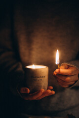 person with candle person is lightning up the candle