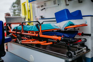 Close-up of empty stretcher inside ambulance vehicle.