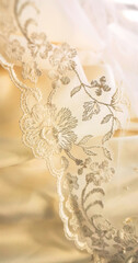 Background of soft bright satin fabric with lace from a wedding dress and veil