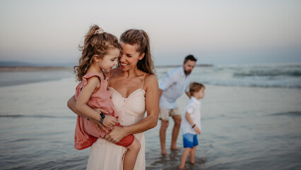 Happy family with little kids enjoying time at sea in exotic country.