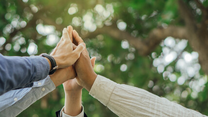 Business people join hands after meeting.World environment day. Global community teamwork.Volunteer...