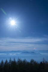 Japan mountain range in hazy blue sunshine.