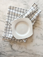 plate on tablecloth for food on a marbel background