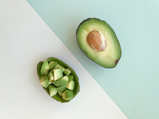 The two halves of an avocado on a colored background