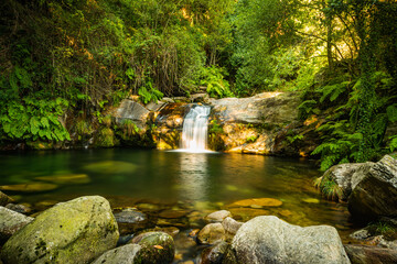 Beautiful water stream in Poço da Cilha waterfall, Manhouce, Sao Pedro do Sul, Portugal. Long exposure smooth effect. Mountain forest landscape.