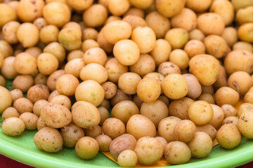 Collection of fresh baby potatoes on a plate.